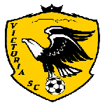 Shield logo for Victoria SC featuring a black eagle perched on a soccer ball, with yellow background and bold text.