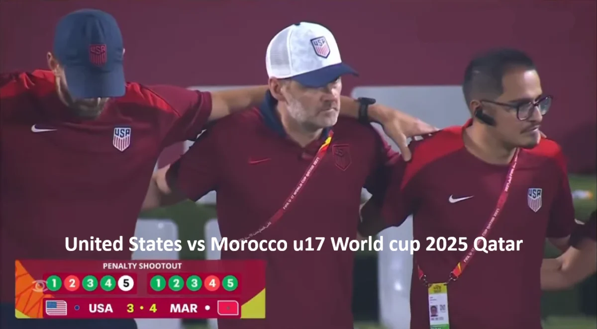 Three members of the USA U-17 national team staff with the head coach Gonzalo Segares stand side by side wearing maroon shirts with the USA soccer logo, arms around each other in a gesture of solidarity. The image follows the conclusion of a FIFA U-17 World Cup Qatar 2025 match between the United States and Morocco. A scoreboard graphic shows the final result of the penalty shootout: Morocco wins 4–3. The penalty sequence is displayed with colored circles — USA: 🟢🔴🟢🔴🟢; Morocco: 🟢🔴🟢🟢🟢. The stadium setting and staff posture reflect emotional resilience and team unity after a narrow defeat. Three members of the USA U-17 national team staff with the head coach Gonzalo Segares stand side by side wearing maroon shirts with the USA soccer logo, arms around each other in a gesture of solidarity. The image follows the conclusion of a FIFA U-17 World Cup Qatar 2025 match between the United States and Morocco. A scoreboard graphic shows the final result of the penalty shootout: Morocco wins 4–3. The penalty sequence is displayed with colored circles — USA: 🟢🔴🟢🔴🟢; Morocco: 🟢🔴🟢🟢🟢. The stadium setting and staff posture reflect emotional resilience and team unity after a narrow defeat.